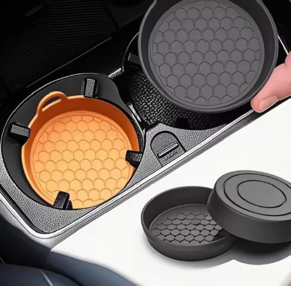 Two silicone honeycomb car coasters in a cup holder
